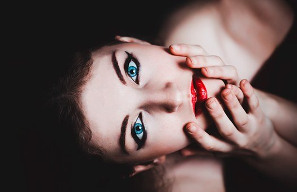 woman with red lipstick and black mascara